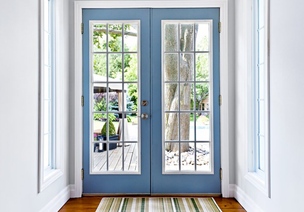Double patio french doors with windows exiting to sunny backyard Double patio french doors with windows exiting to sunny backyard